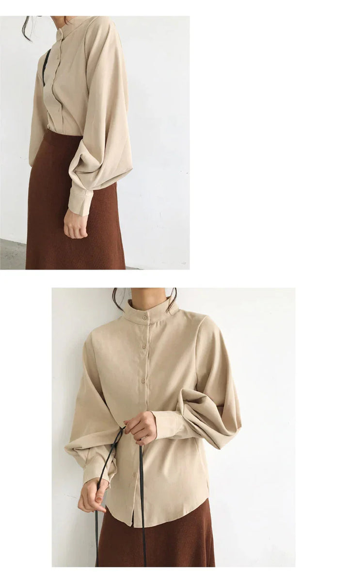 Woman wearing beige button-up blouse with puffed sleeves and brown skirt in minimalist setting