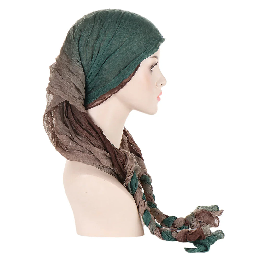 Side profile of mannequin wearing soft green and brown braided headscarf on white background