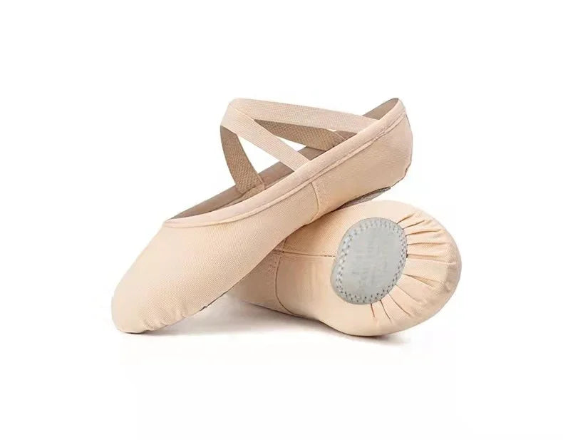 Beige ballet slippers with crisscross elastic straps and split sole design on white background