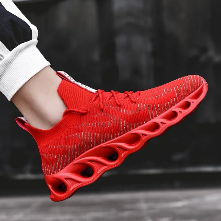 Red lightweight running shoe with breathable knit upper and unique ventilated sole, worn with black and white pants