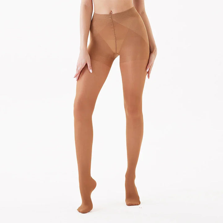 woman wearing sheer brown pantyhose standing against white background