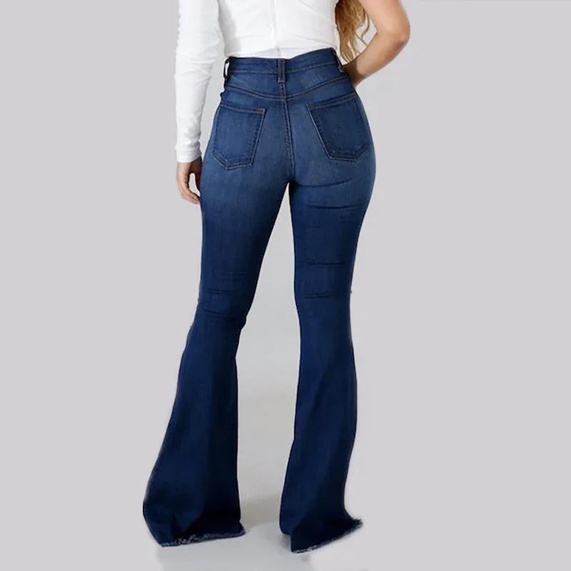 Rear view of woman wearing dark blue high-waisted denim flare jeans with back pockets