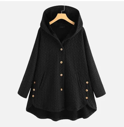 Black quilted hooded jacket with front buttons and side button accents hanging on wooden hanger