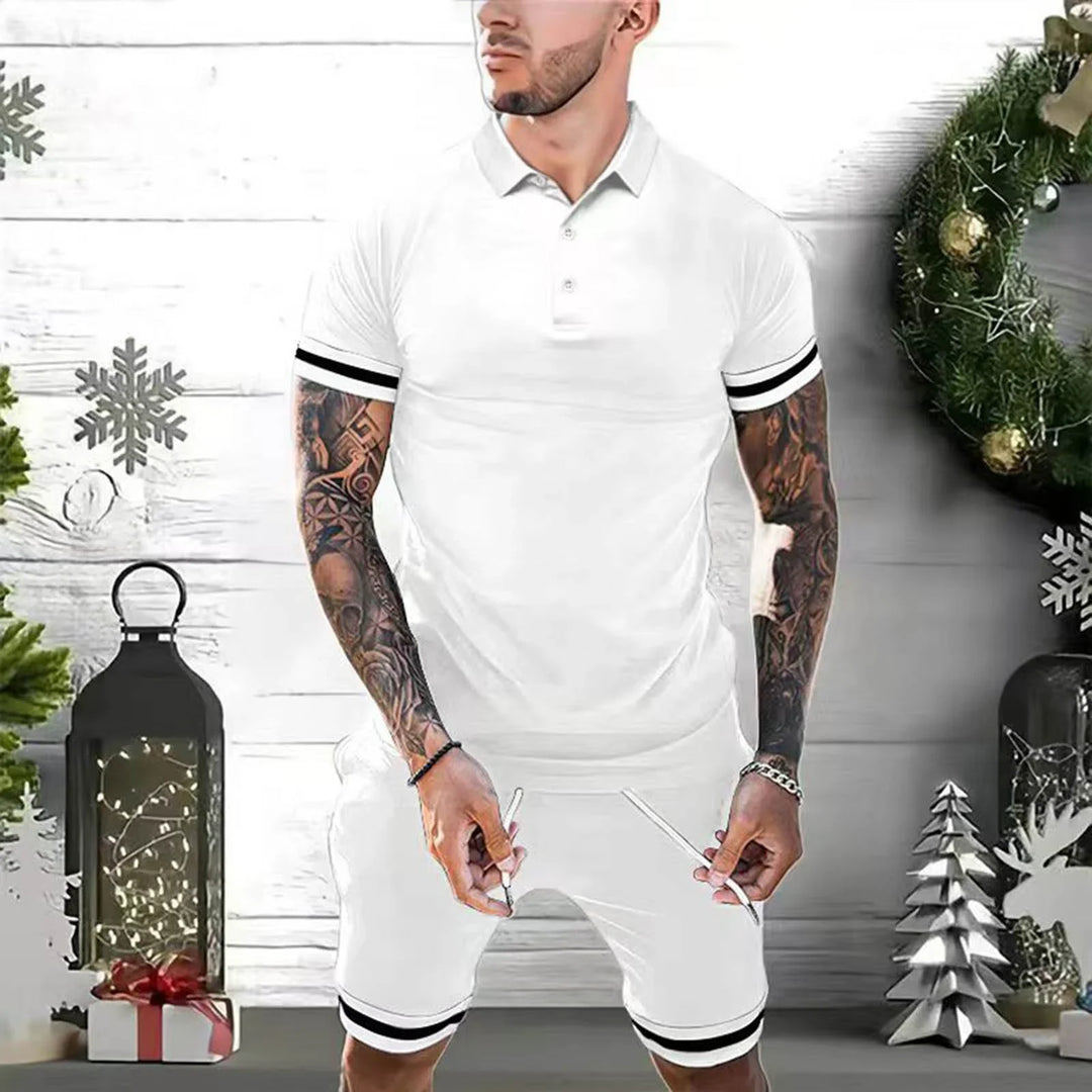 Man wearing white polo shirt and matching shorts with black stripes, posing in festive holiday setting