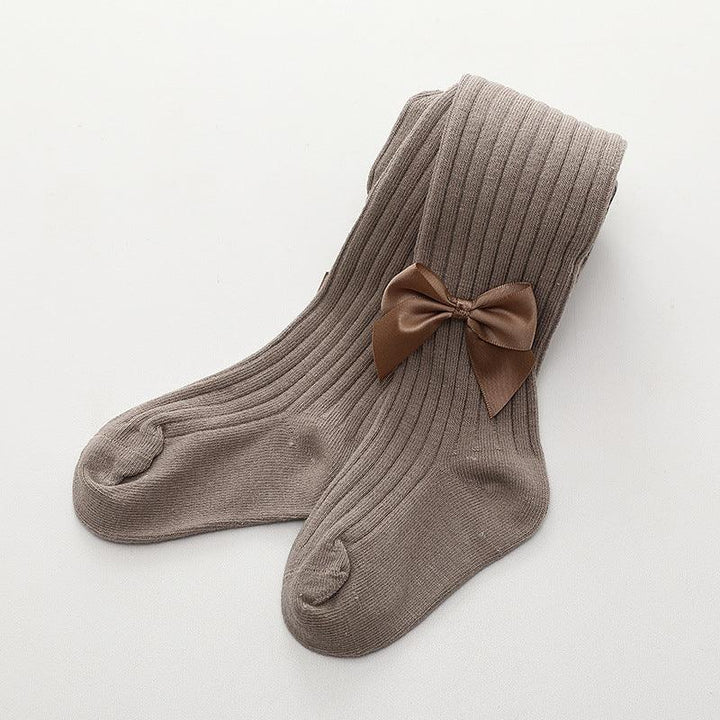 Pair of ribbed taupe knee-high socks with a decorative brown satin bow on white background