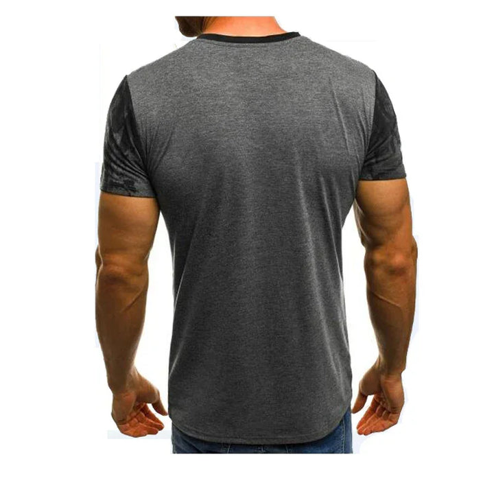 Back view of a man wearing a fitted charcoal gray and black short sleeve t-shirt with jeans