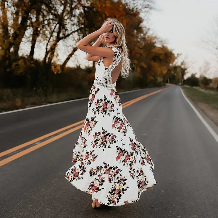 Woman wearing a white floral maxi dress with lace detail standing on an empty road during autumn