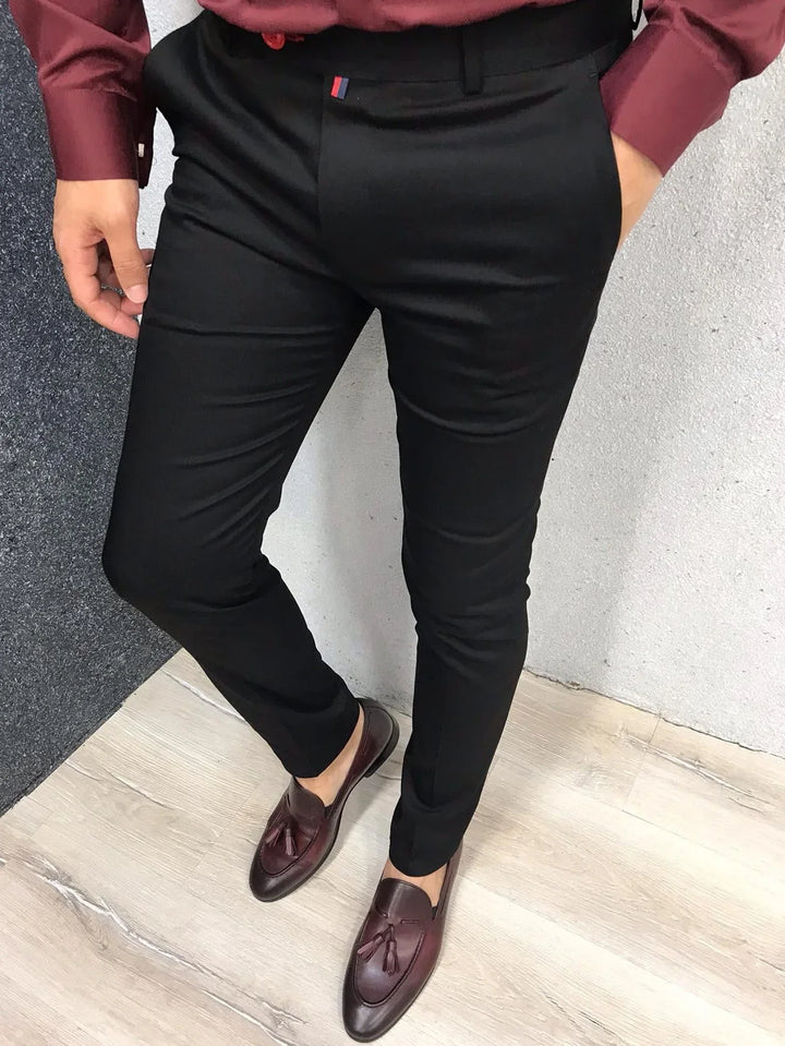 Man wearing slim fit black formal trousers paired with burgundy tassel loafers and matching shirt