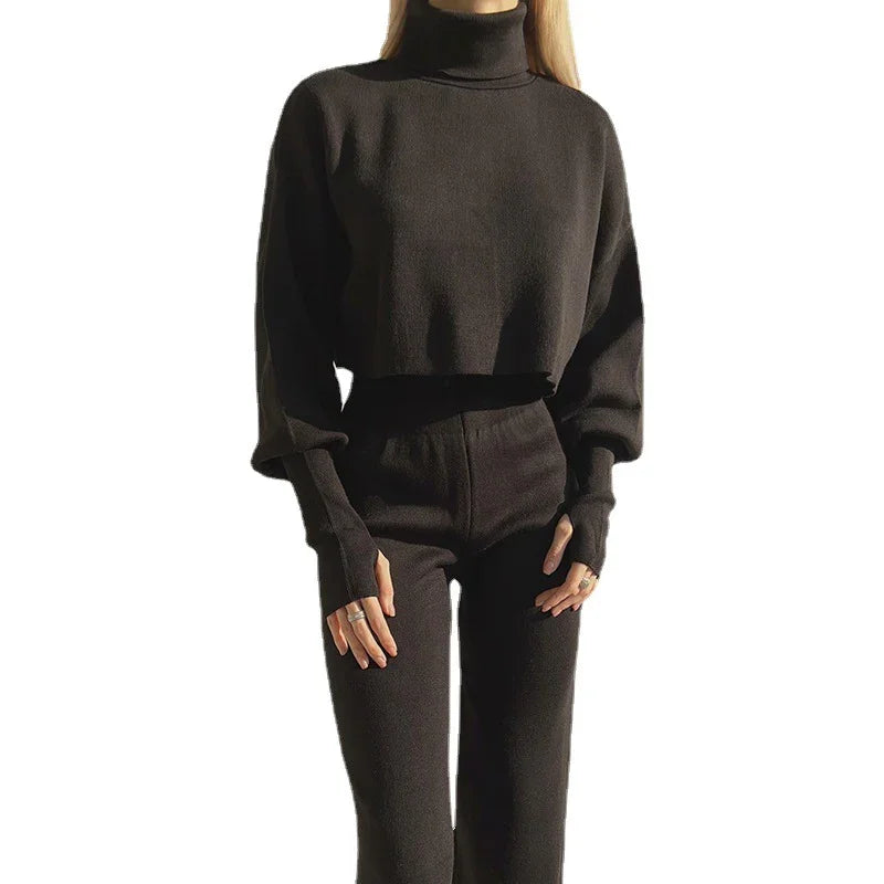 Woman wearing a black knitted turtleneck sweater and matching high-waisted pants set