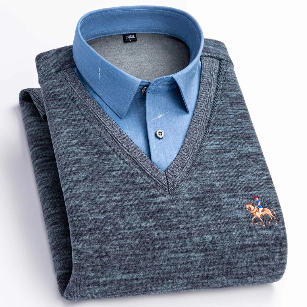 Folded men's blue dress shirt with grey V-neck sweater featuring horse rider embroidery