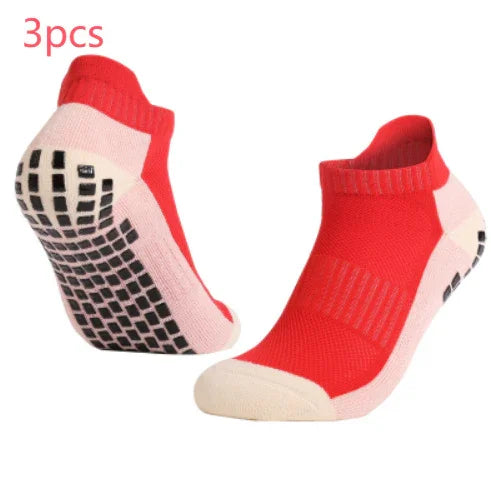 Pair of red and white non-slip grip ankle socks with black rubberized sole pads