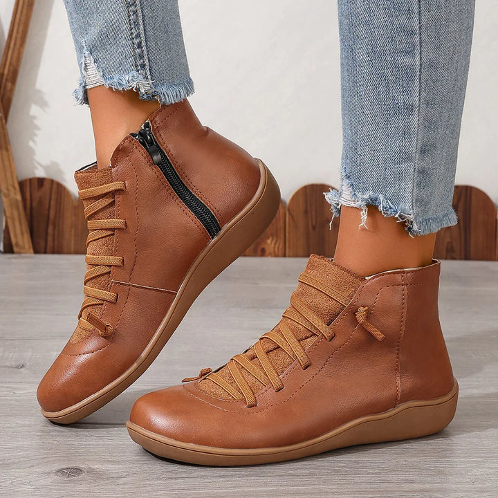 Casual brown leather ankle boots with side zipper and laces worn with frayed hem jeans