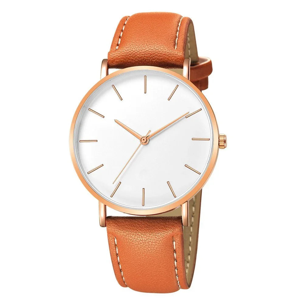 Minimalist wristwatch with rose gold case and tan leather strap on white background