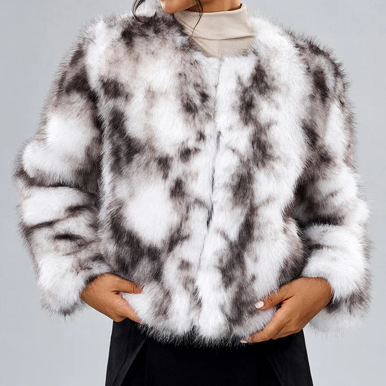 Woman wearing white and black spotted faux fur coat with hands in pockets