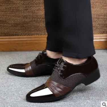 Close-up of polished men's brown leather dress shoes with textured panels and pointed toes