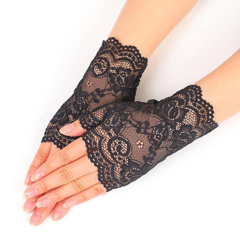 hands wearing black floral lace fingerless gloves on white background
