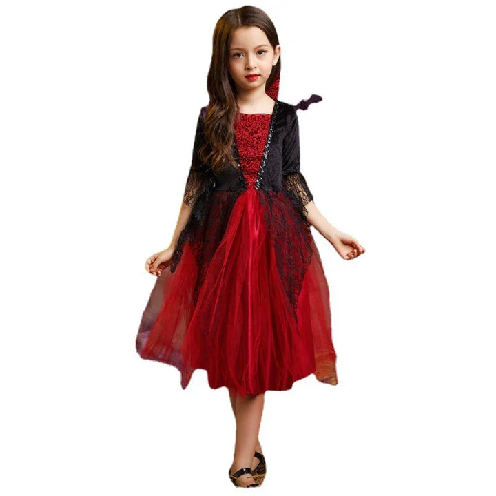 Young girl wearing a red and black lace Halloween costume dress with tulle skirt