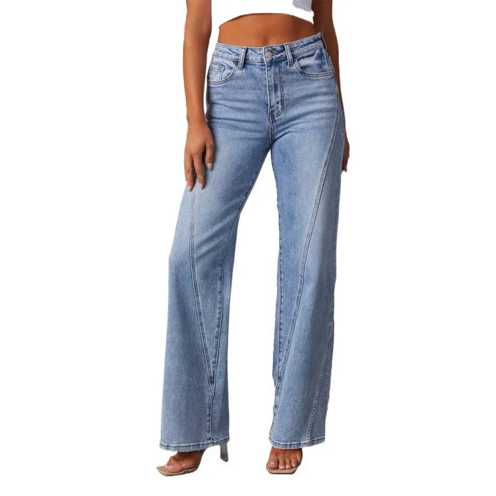 Women’s high-waisted light blue wide-leg jeans worn with clear high heel sandals