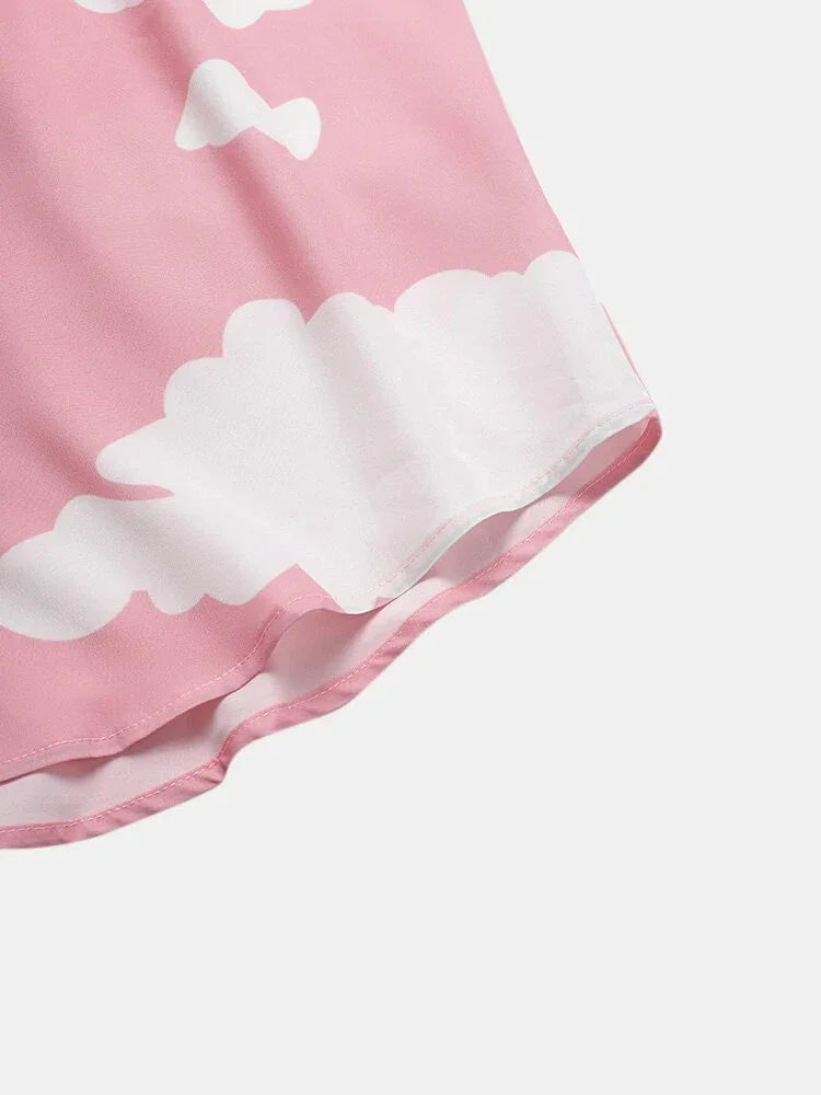 Close-up of pink fabric with white cloud pattern and neat stitching detail