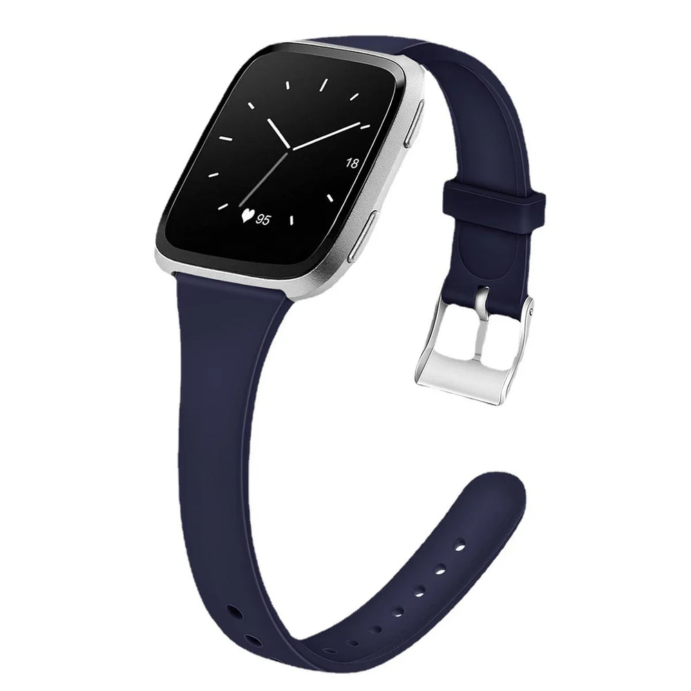 Silver smartwatch with black screen showing time, heart rate, and navy blue silicone strap