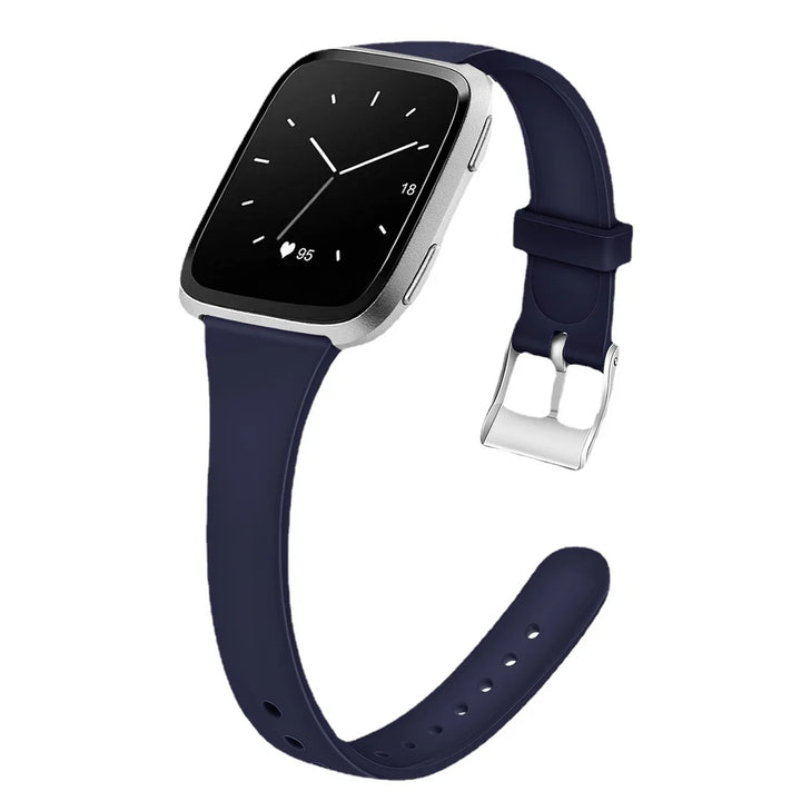 Silver smartwatch with black screen showing time, heart rate, and navy blue silicone strap