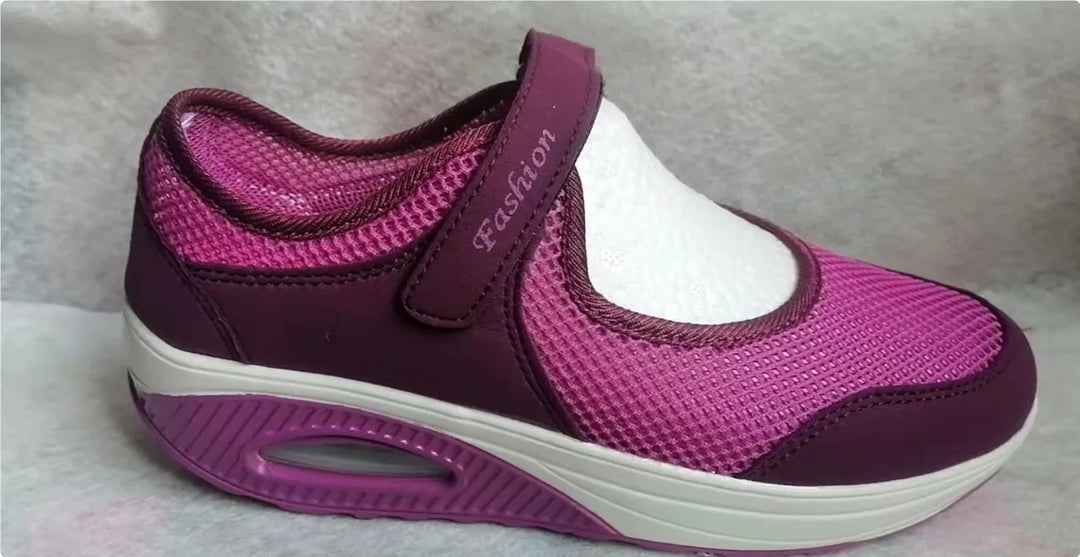 Purple and pink sporty walking shoe with mesh design and Velcro strap labeled Fashion