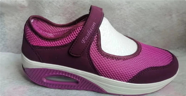 Purple and pink sporty walking shoe with mesh design and Velcro strap labeled Fashion