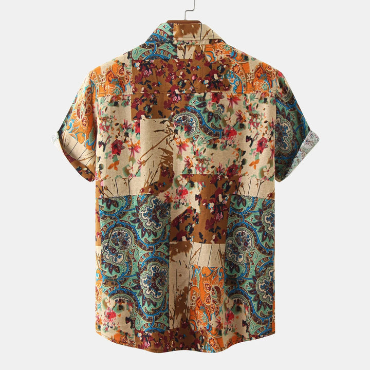 Back view of colorful patchwork short sleeve shirt with floral and paisley patterns