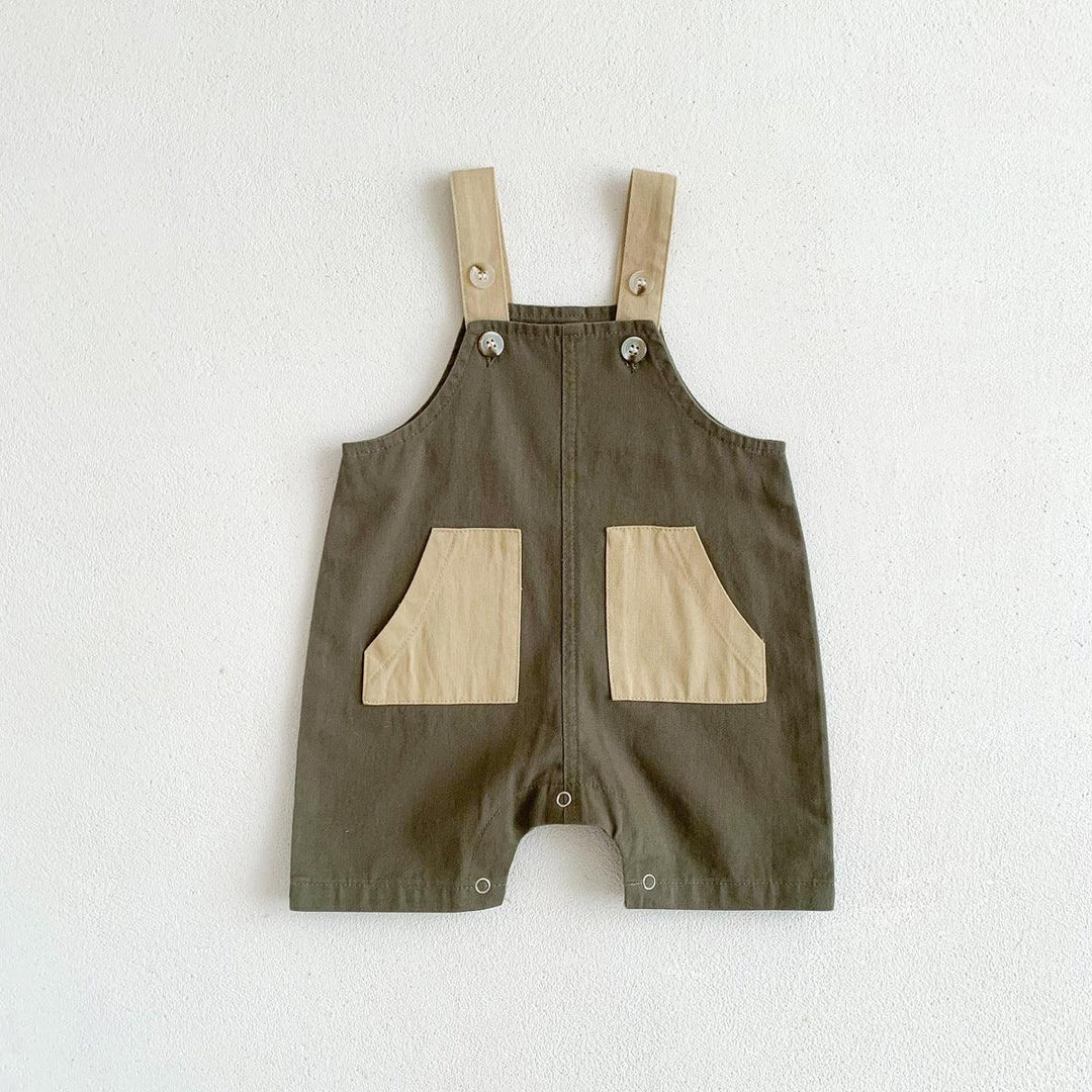Olive green baby romper with beige pockets and buttoned shoulder straps on white background