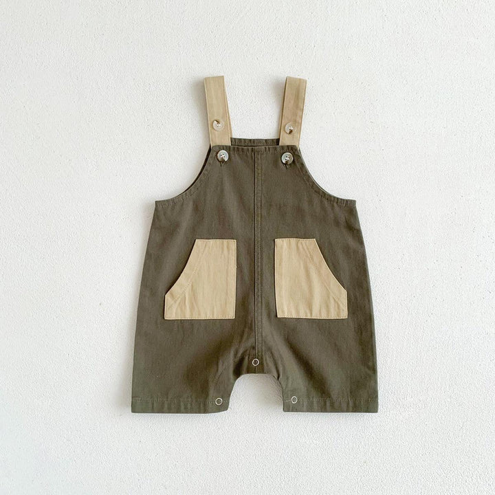 Olive green baby romper with beige pockets and buttoned shoulder straps on white background