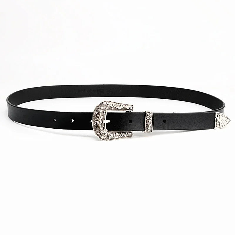 Black leather belt with ornate silver floral embossed buckle, loop, and tip on white background