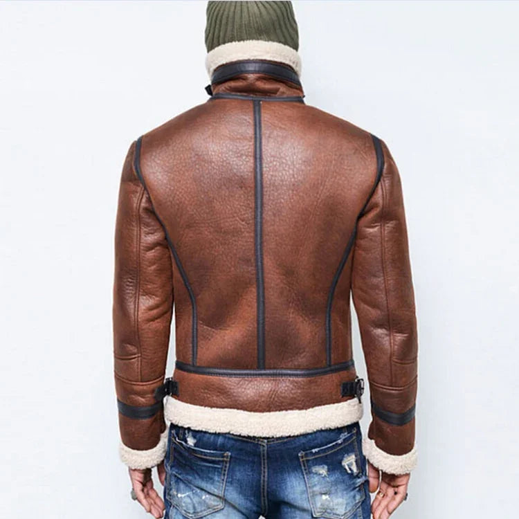 Back view of man wearing brown shearling leather jacket with black trim and blue distressed jeans