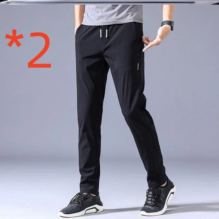 Man wearing black casual jogger pants with grey t-shirt and black sneakers