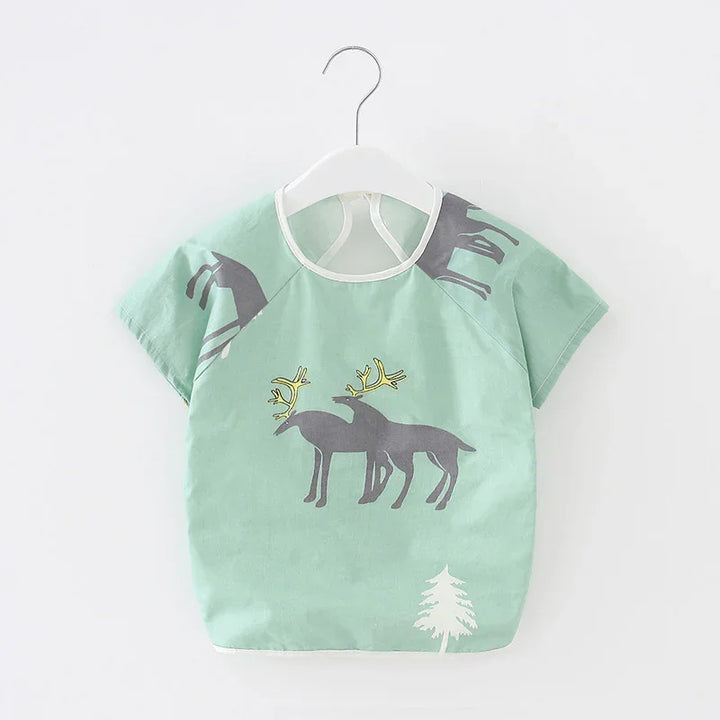 Mint green baby bib with grey reindeer and a white tree print, hanging on white hanger