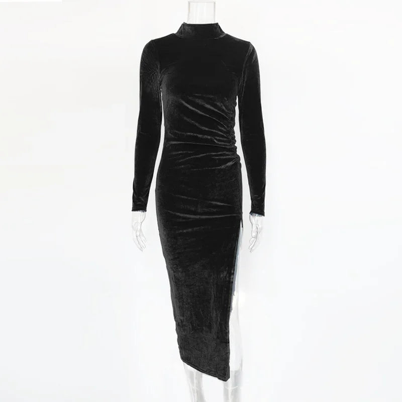 Long black velvet dress with high neck, long sleeves, and asymmetrical hem on mannequin