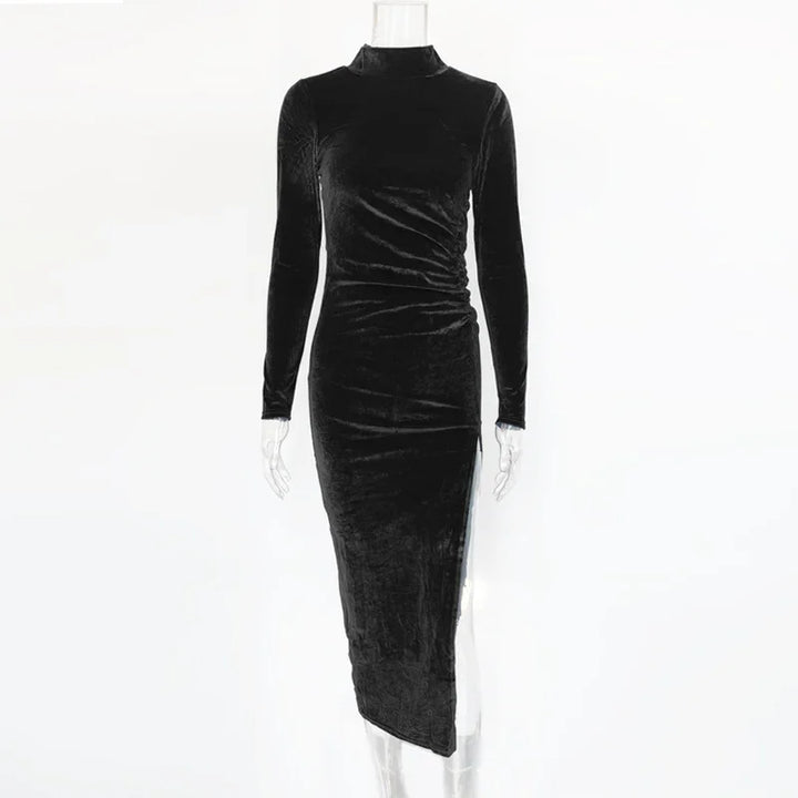 Long black velvet dress with high neck, long sleeves, and asymmetrical hem on mannequin
