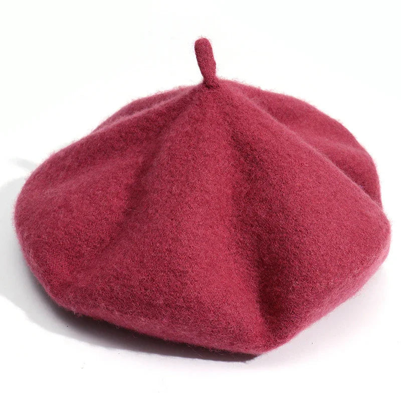 Classic red wool beret hat with top loop on white background