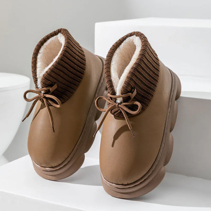 brown winter boots with ribbed knit cuffs, fleece lining, and round laces on white display