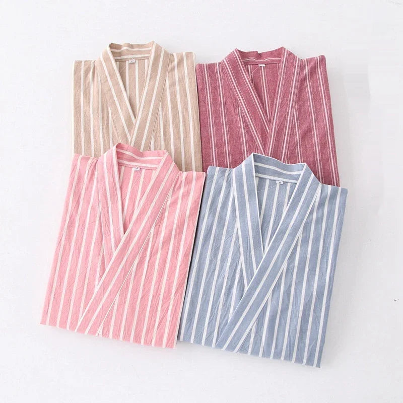 Four folded striped kimono-style robes in beige, burgundy, pink, and blue on white background