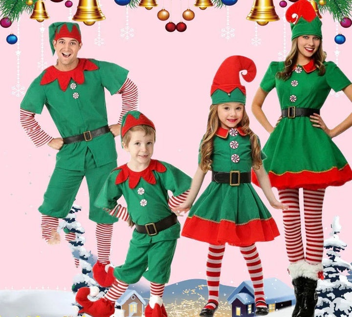 Family of four in festive Christmas elf costumes with green outfits, red collars, striped tights, and elf hats
