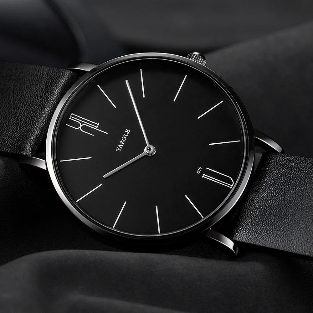 Minimalist black Yazole wristwatch with silver hands and black leather strap on black fabric