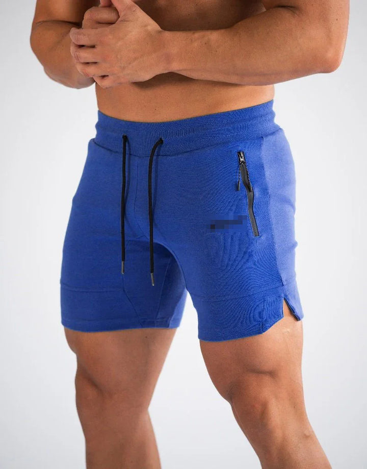muscular man wearing blue athletic shorts with black drawstring and zippered side pocket