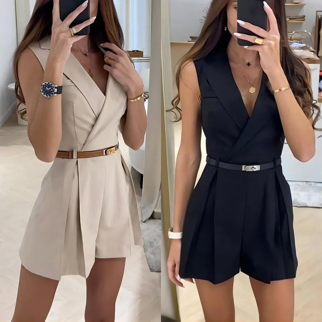 Woman modeling sleeveless belted v-neck romper in beige and black with gold accessories indoors