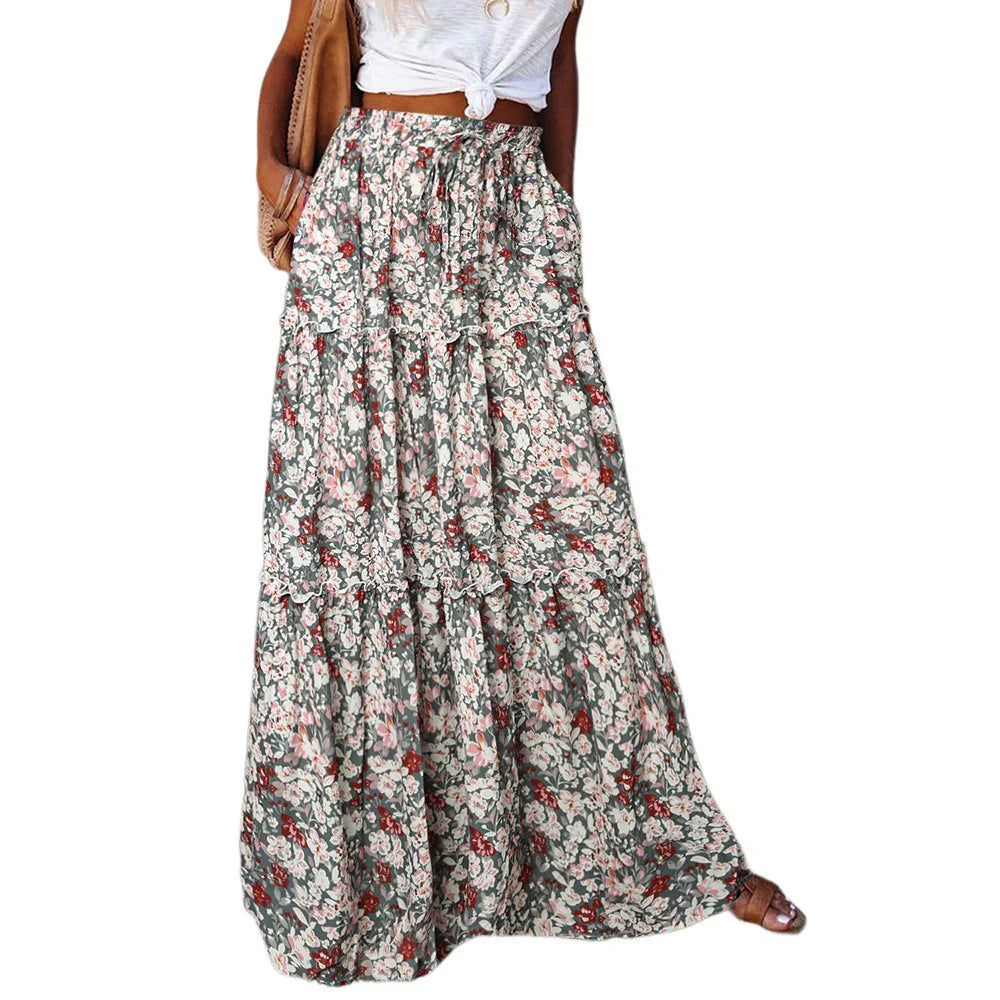 Woman wearing a long floral print skirt paired with a white knotted crop top and brown sandals