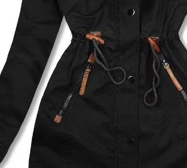 Close-up of black jacket with adjustable drawstring waist and brown leather zipper pulls