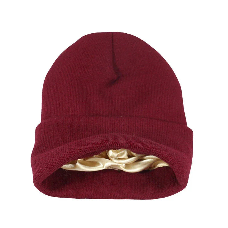 Maroon knit beanie hat with beige satin lining, winter warm headwear on white background