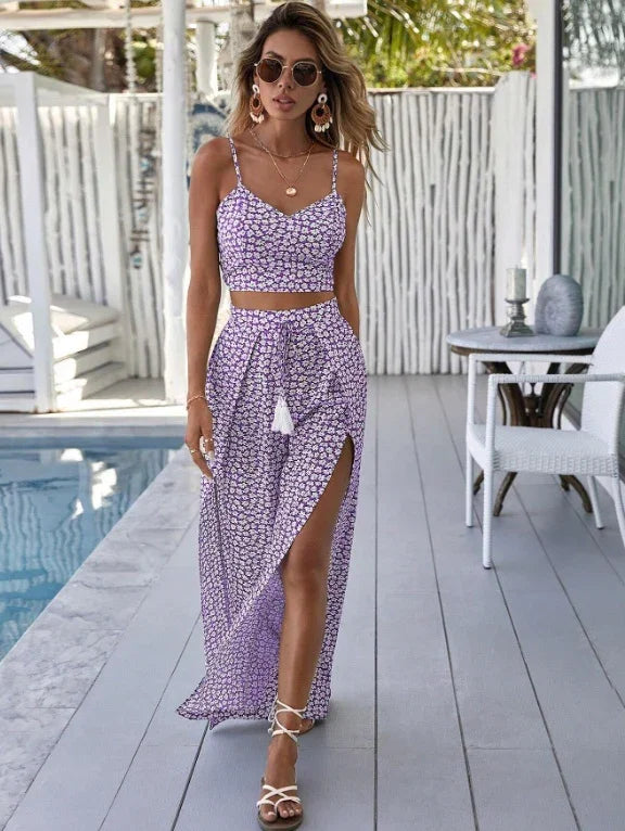 Woman wearing purple floral two-piece outfit walking by poolside on wooden deck in summer fashion
