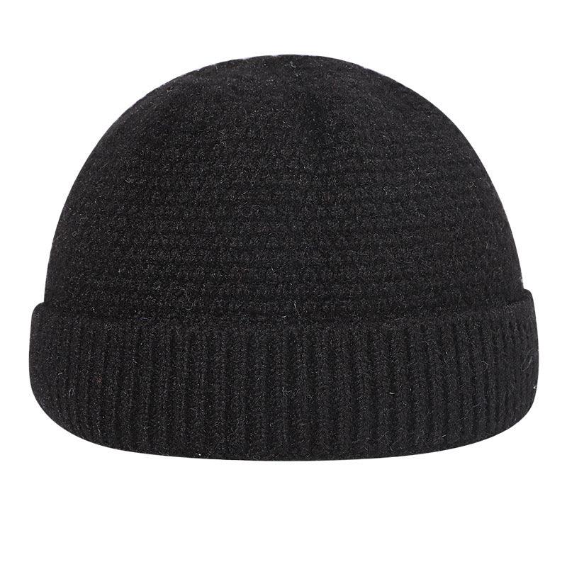 Black knit wool beanie hat with folded cuff, winter accessory on white background