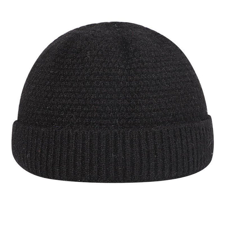 Black knit wool beanie hat with folded cuff, winter accessory on white background