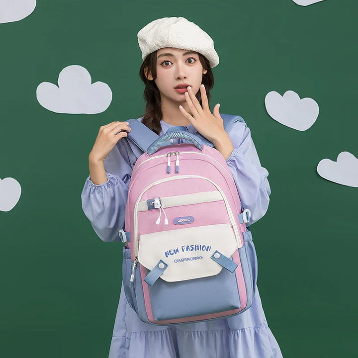 Young woman in lavender dress and white beret holding pink and blue New Fashion backpack against green background with white clouds